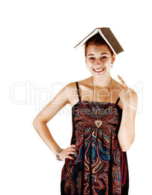 Girl with book on head.