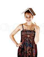 Girl with book on head.