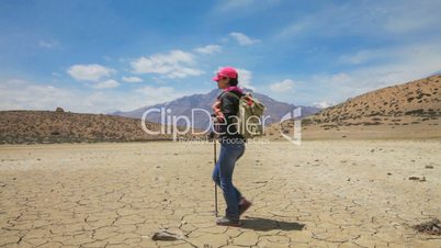 Woman traveler goes on a dry mountain lake