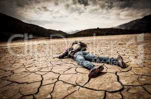 person lays on the dried ground