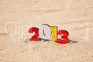 Wooden 2013 year number on the sand