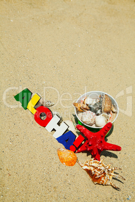 Wooden colorful word 'Aloha' on the sand