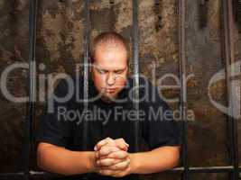 Young man behind the bars