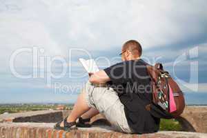 Young man sitting outdoors and meditating