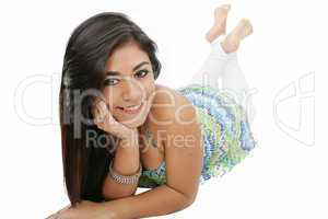 Portrait of a smiling young woman lying on the floor isolated on