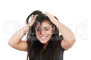 A portrait of a young frustrated woman pulling out hair over whi