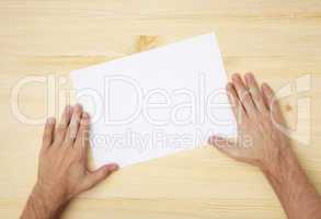 human hand holds a blank paper