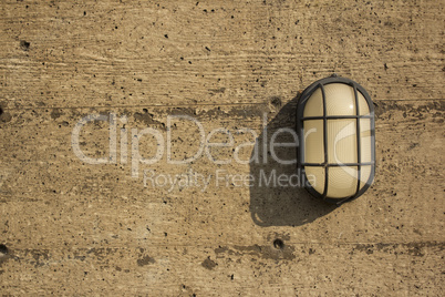 A wall light on a distressed wall