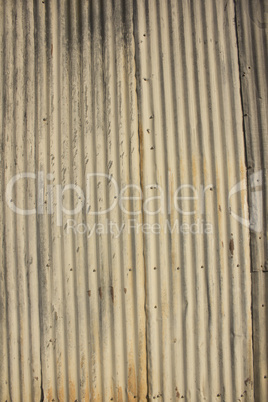 Rusty damaged corrugated metal surface texture.