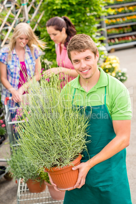Garden centre worker hold potted plant