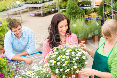 Florist assist woman choose flowers garden store