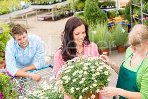 Florist assist woman choose flowers garden store