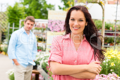 Smiling woman standing at garden center