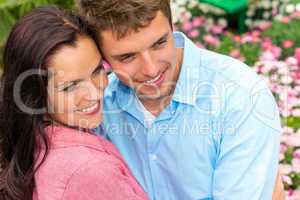 Happy couple hugging in blooming garden
