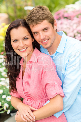 Happy couple embracing in nature garden