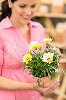 Woman hold yellow potted flower