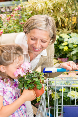 Garden center girl with grandmother smell flower