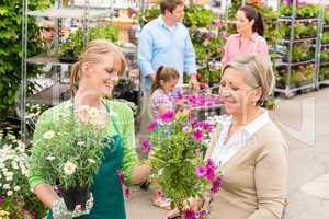 Customer at garden centre buying potted flowers