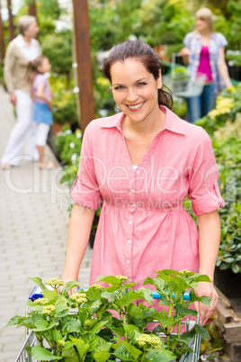 Woman at garden centre shopping for flowers