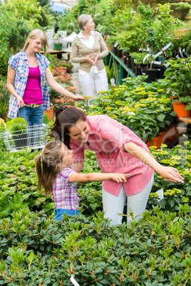 Mother daughter choosing flowers in garden center