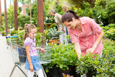 Garden centre child mother shopping flowers plant