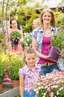 Garden center woman with girl buying flowers