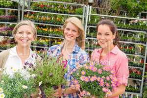 Women garden centre shop hold potted flower