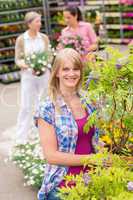 Woman hold tree plant at garden center