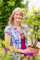 Woman hold tree plant at garden center