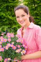 Female florist hold pink potted flower