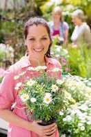 Woman hold potted flowers at garden centre