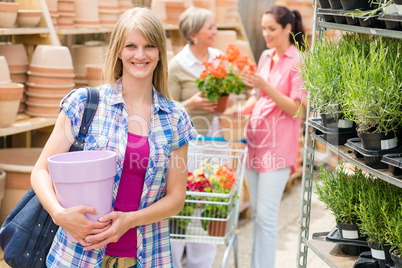 Woman hold flower pot garden centre store