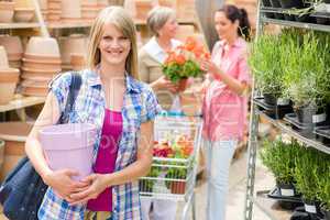 Woman hold flower pot garden centre store