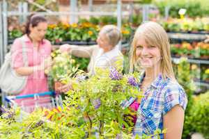 Smiling woman at garden centre shopping plants