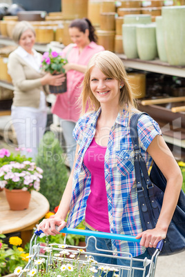 Woman with shopping cart in garden shop