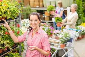 Woman buying potted flower in garden shop