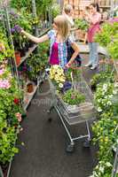 Woman at garden centre shopping for flowers