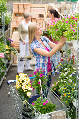 Woman shopping for flowers in garden centre