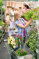Woman shopping for flowers in garden centre
