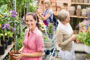 Woman hold potted plant at garden shop