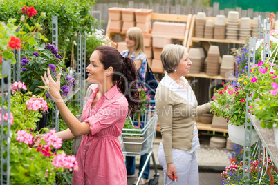 Woman taking potted plant at garden center