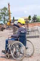 Architect shows disabled woman in wheelchair construction sites