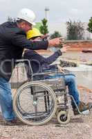 Architect shows disabled woman in wheelchair construction sites