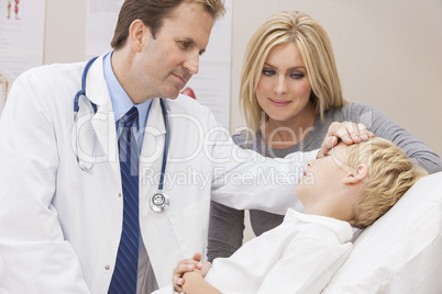 Male Doctor Examining Boy Child With Mother