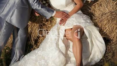 Bride and fiance on a haystack