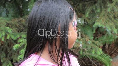Cute Asian Girl Showing Off Her Face Paint Design