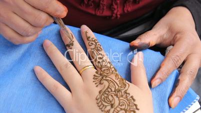 Woman Getting A Henna Tattoo On Her Fingers