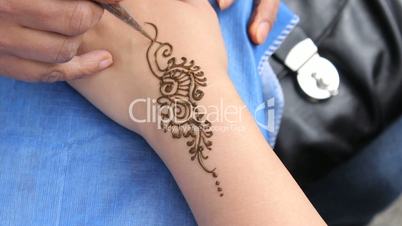 Woman Getting A Henna Tattoo On Her Wrist