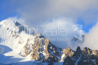 snow-capped peaks and clouds