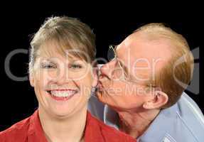 Middle Aged Husband Kisses Wife